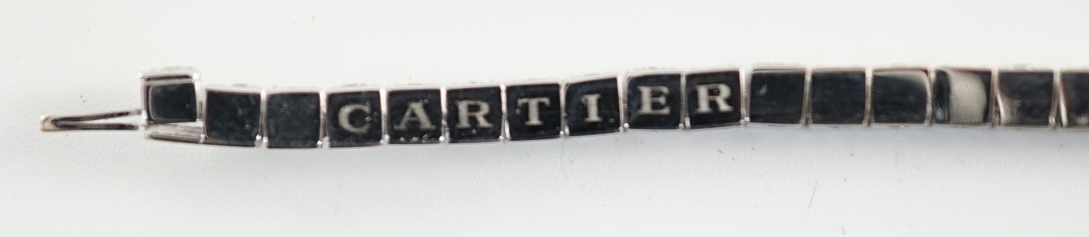 A late 20th century Cartier 18ct white gold and diamond set line bracelet